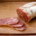 Slices of salami on a wooden board